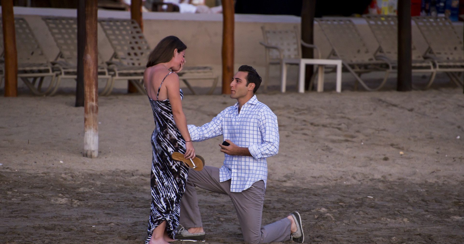 Brian proposes to Emma on a beach.