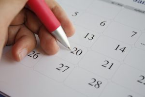 Hand selecting dates on a calendar
