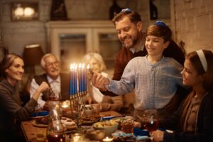 Jewish family celebrating Menorah