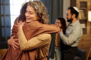 Two women hugging each other.